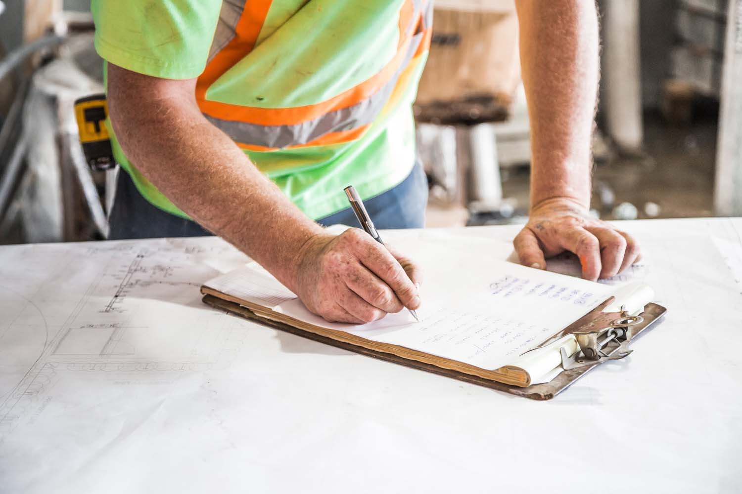 Man writing on a clipboard