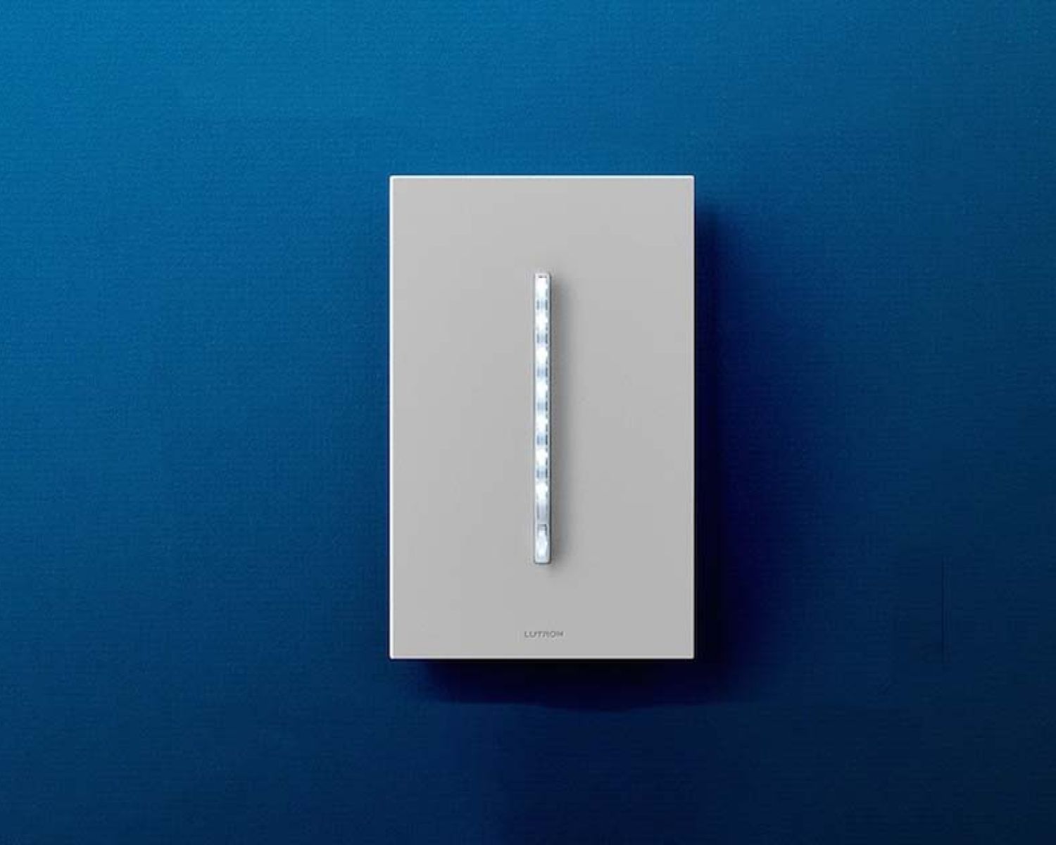 Lutron wall-mounted dimmer switch on a blue background.