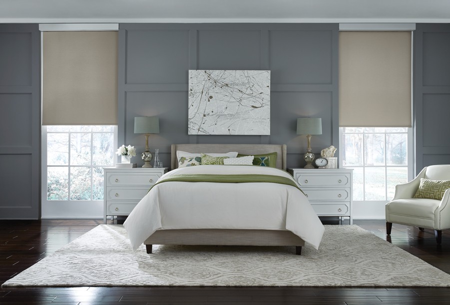  two large windows on either side of the bed. Both windows have partially drawn smart shades.