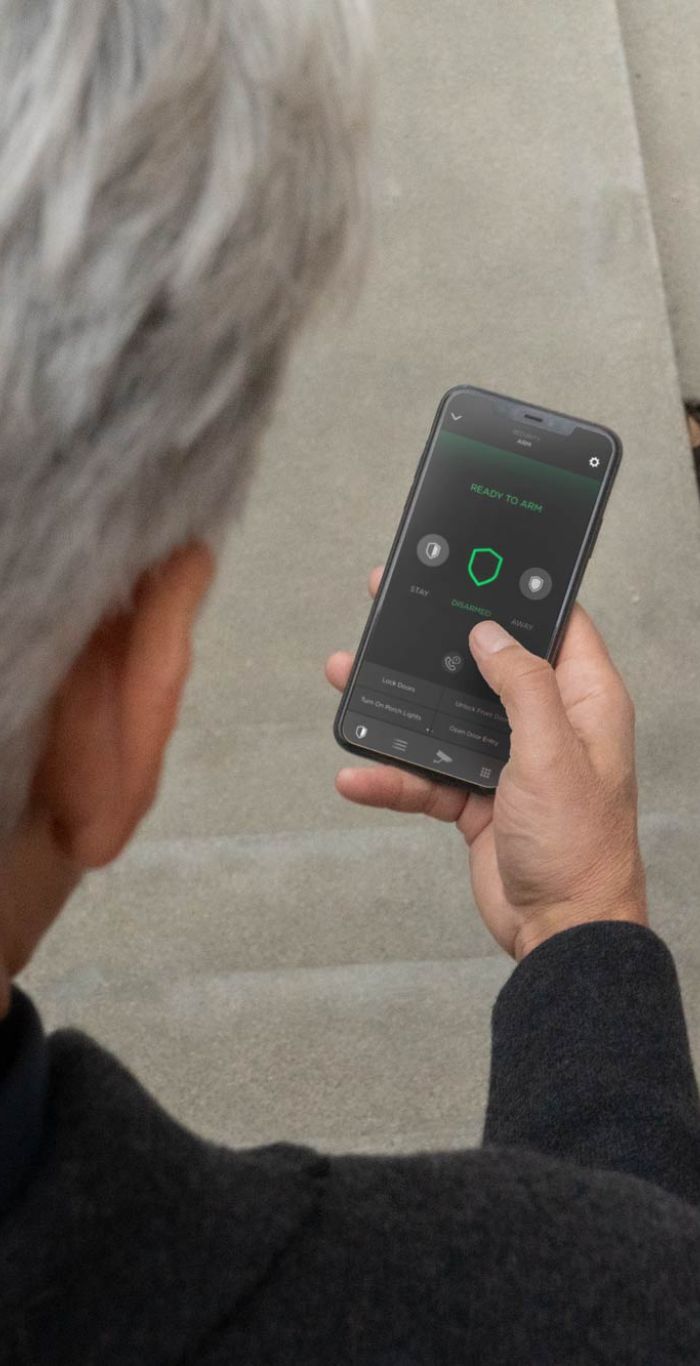 woman using a phone to enter her door, smart technology
