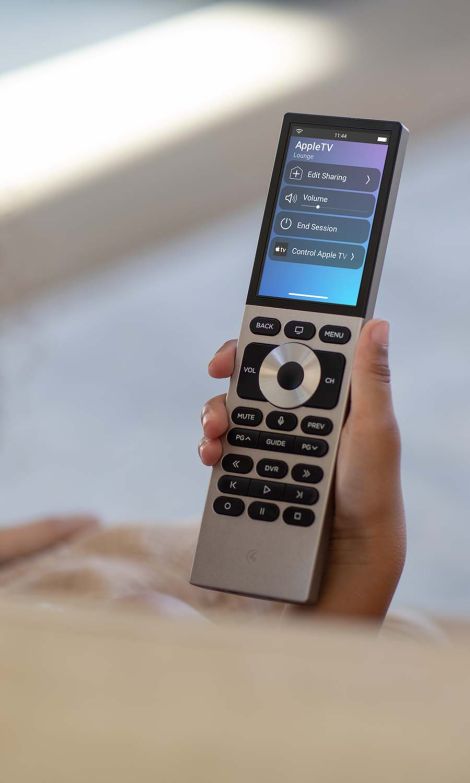 red control4 neeo remote in a leather couch