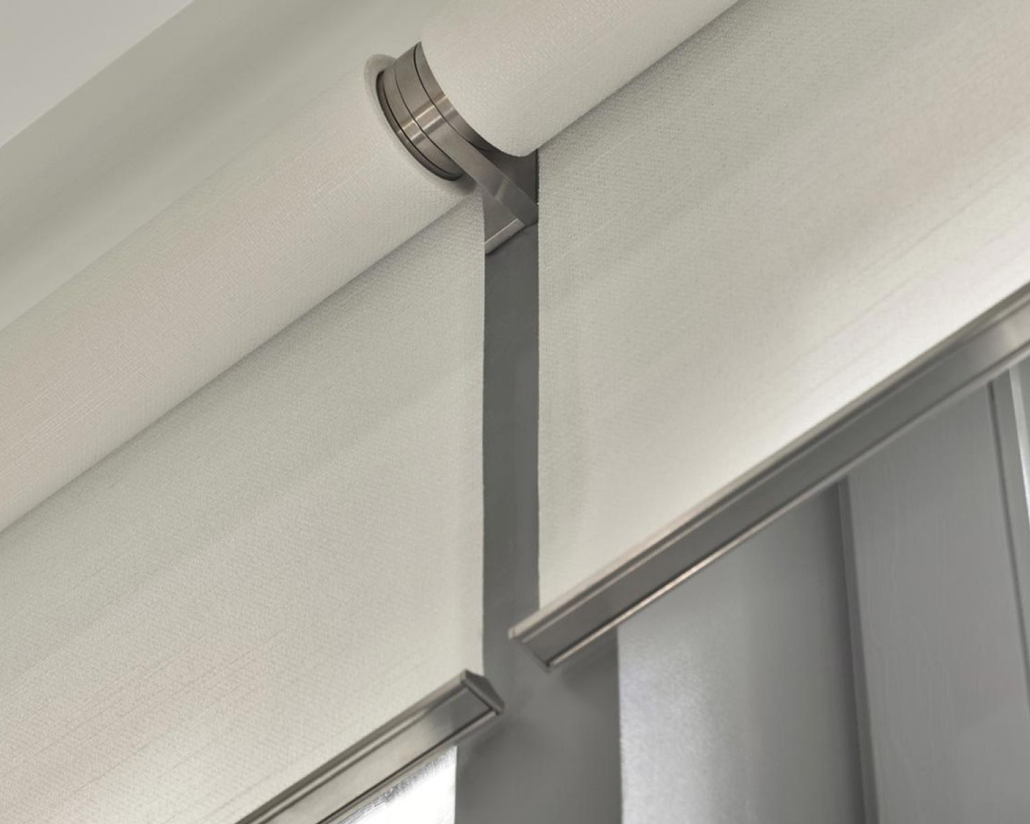 Close-up of a Lutron Palladiom roller shade mechanism in a metallic finish.